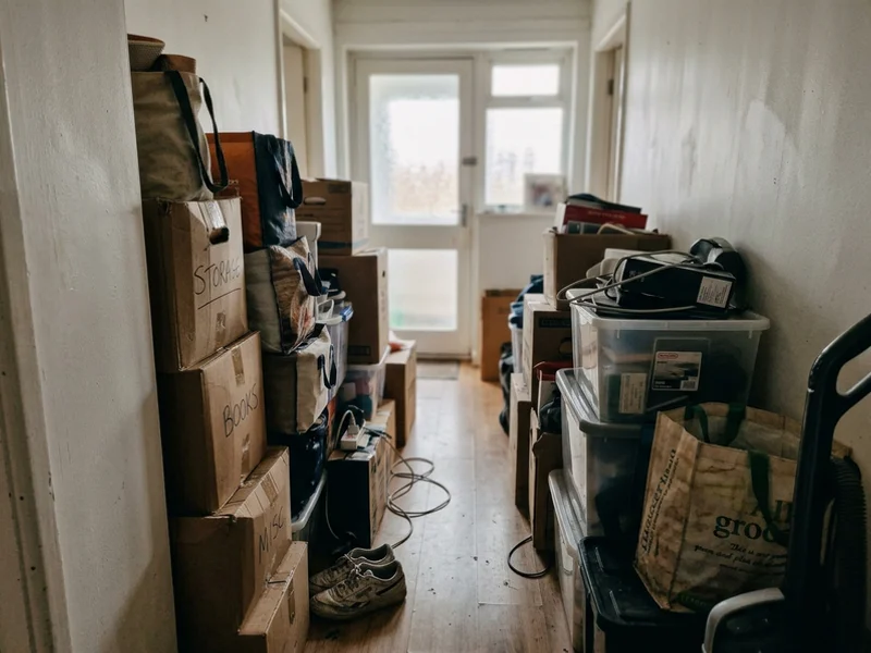 Level 2 hoarding conditions with a narrow path through stacked belongings